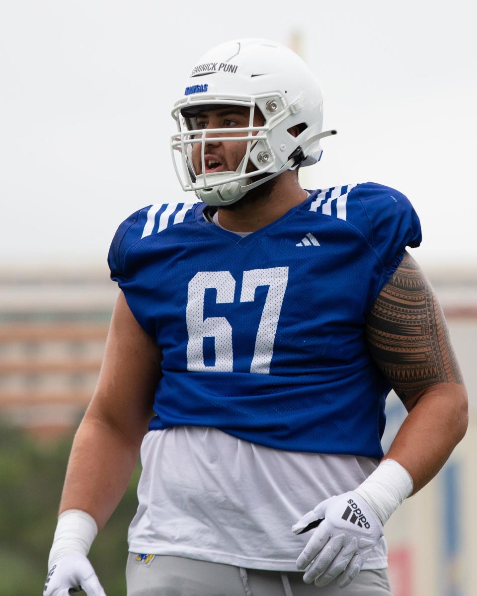 Kansas football offensive lineman Dominick Puni looks on during a 2023 fall practice in Lawrence.