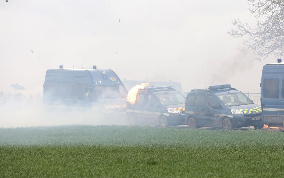 A riot mobile gendarmes' vehicle burns during protests against the construction of a new water reserve for agricultural irrigation, in Sainte-Soline - AFP