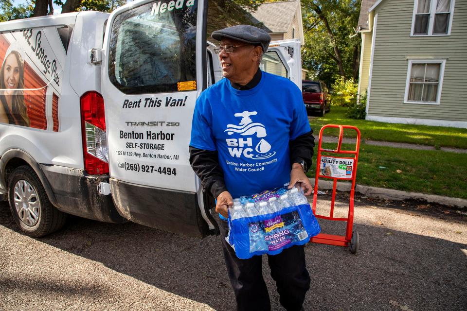 The Rev. Edward Pinkney, president of the grassroots Benton Harbor Community Water Council, works with volunteers to go door to door in Benton Harbor passing out bottled water on Oct. 26, 2021. Many of the residents he delivers water to do not have transportation or are not physically able to go to one of the many water distribution locations across the city.