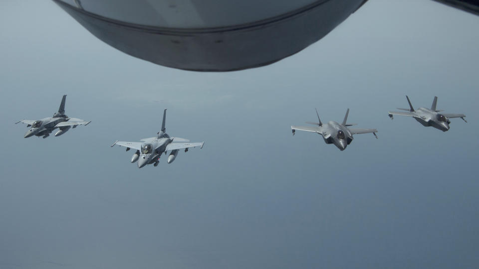 FILE - In this May 29, 2019 file photo released by the U.S. Air Force, United Arab Emirates Air Force Desert Falcons fly in formation with U.S. F-35A Lightning IIs in an undisclosed location in Southwest Asia. Tensions between the United States and Iran have soared in recent weeks, with Washington dispatching warships and bombers around the Persian Gulf, and Tehran threatening to resume higher uranium enrichment. The tensions come a year after President Donald Trump withdrew from Iran’s 2015 nuclear accord with world powers and restored crippling sanctions. (Staff Sgt. Chris Drzazgowski/U.S. Air Force via AP, File)