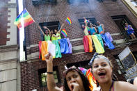 NEW YORK - JUNE 24: Revelers cheer during the New York City Gay Pride March on June 24, 2012 in New York City. The annual civil rights demonstration commemorates the Stonewall riots of 1969, which erupted after a police raid on a gay bar, the Stonewall Inn on Christopher Street. (Photo by Michael Nagle/Getty Images)