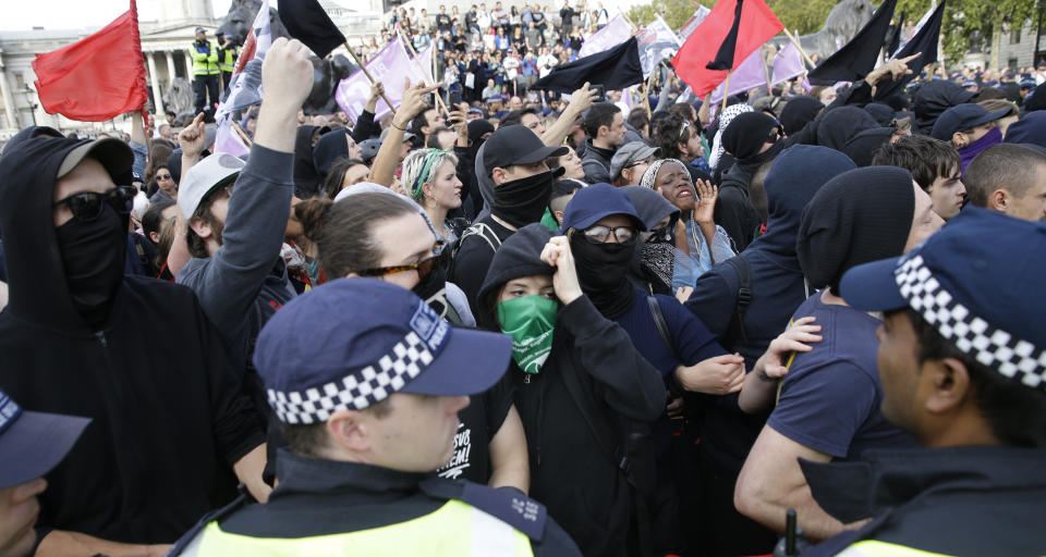 Anti-fascist's demonstrators protest against a rival march by the Football Lads Alliance march in London, Saturday, Oct. 13, 2018. (AP Photo/Alastair Grant)