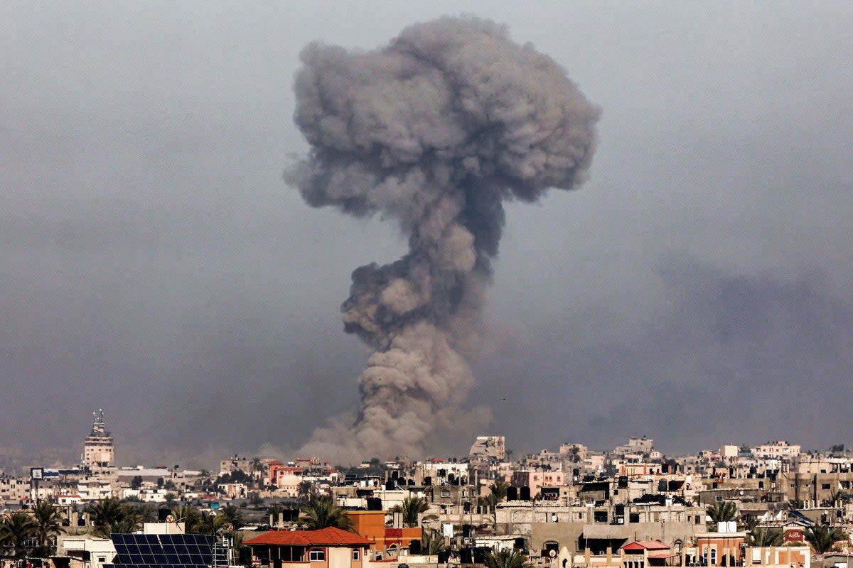 A smoke plume erupts over Khan Yunis from Rafah in the southern Gaza strip during Israeli bombardment on January 8 (AFP via Getty Images)