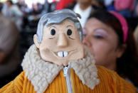 A supporter holds a figure of leftist front-runner Andres Manuel Lopez Obrador of the National Regeneration Movement (MORENA), as she takes part in his campaign rally in Cuautitlan Izcalli, Mexico, April 13, 2018. REUTERS/Henry Romero