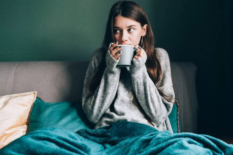 Shivering, frost brunette woman in sweater