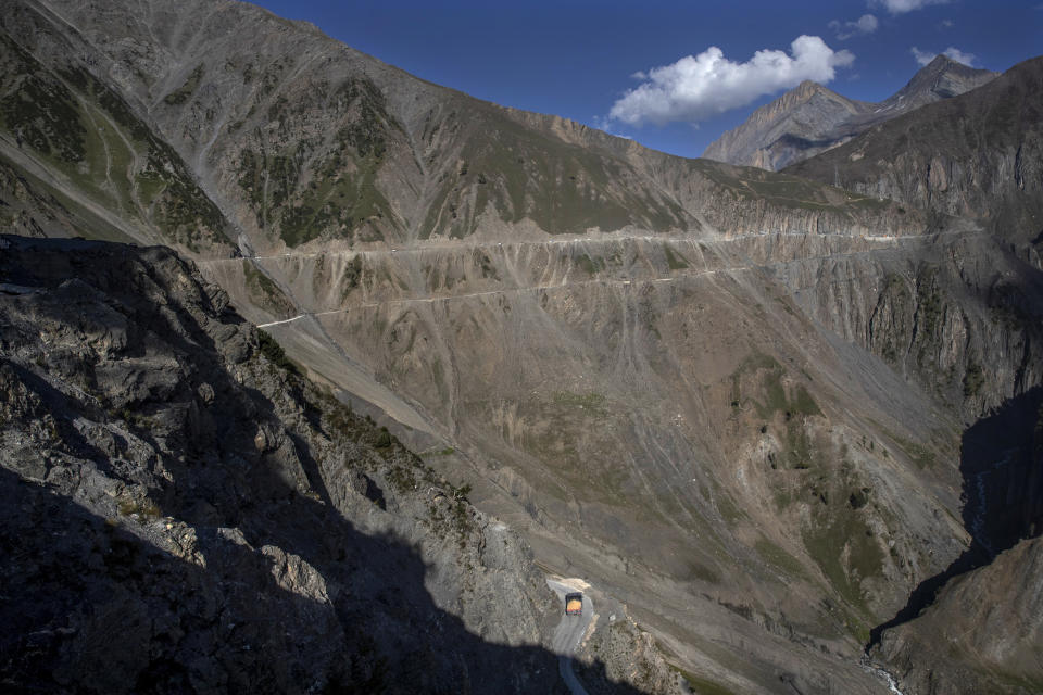 Vehicles run through the Zojila Pass, northeast of Srinagar, Indian controlled Kashmir, Monday, Sept. 27, 2021. High in a rocky Himalayan mountain range, hundreds of people are working on an ambitious project to drill tunnels and construct bridges to connect the Kashmir Valley with Ladakh, a cold-desert region isolated half the year because of massive snowfall. The $932 million project’s last tunnel, about 14 kilometers (9 miles) long, will bypass the challenging Zojila pass and connect Sonamarg with Ladakh. Officials say it will be India’s longest and highest tunnel at 11,500 feet (3,485 meters). (AP Photo/Dar Yasin)