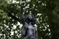 A new black resin and steel statue entitled "A Surge of Power (Jen Reid) 2020" by artist Marc Quinn stands after the statue was put up this morning on the empty plinth of the toppled statue of 17th century slave trader Edward Colston, which was pulled down during a Black Lives Matter protest in Bristol, England, Wednesday, July 15, 2020. On June 7 anti-racism demonstrators pulled the 18-foot (5.5 meter) bronze likeness of Colston down, dragged it to the nearby harbor and dumped it in the River Avon — sparking both delight and dismay in Britain and beyond. (AP Photo/Matt Dunham)