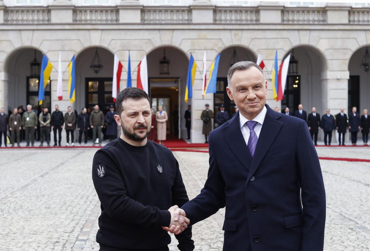 Ukraine's President Volodymyr Zelensky (L) and Polish President Andrzej Duda shake hands during a welcoming ceremony in front of the presidential palace in Warsaw (AFP via Getty Images)