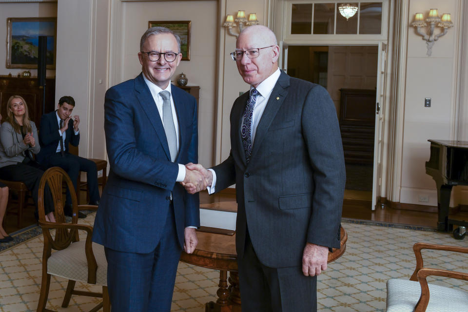 Australian Prime Minister Anthony Albanese, left, is congratulated by Australian Governor-General David Hurley, right, after his swearing in ceremony at Government House in Canberra, Monday, May 23, 2022. Albanese has been sworn in ahead of a Tokyo summit while vote counting continues to decide whether he will control a majority in a Parliament that is demanding tougher action on climate change. (Lukas Coch/AAP Image via AP)