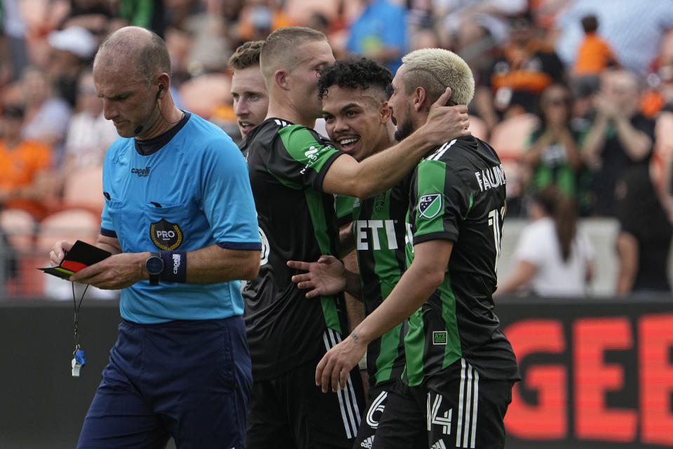Austin FC's Daniel Pereira (6) celebrates with Diego Fagúndez (14) and Alexander Ring after scoring a goal against the Houston Dynamo during the first half of a MLS soccer match Saturday, April 30, 2022, in Houston. (AP Photo/David J. Phillip)