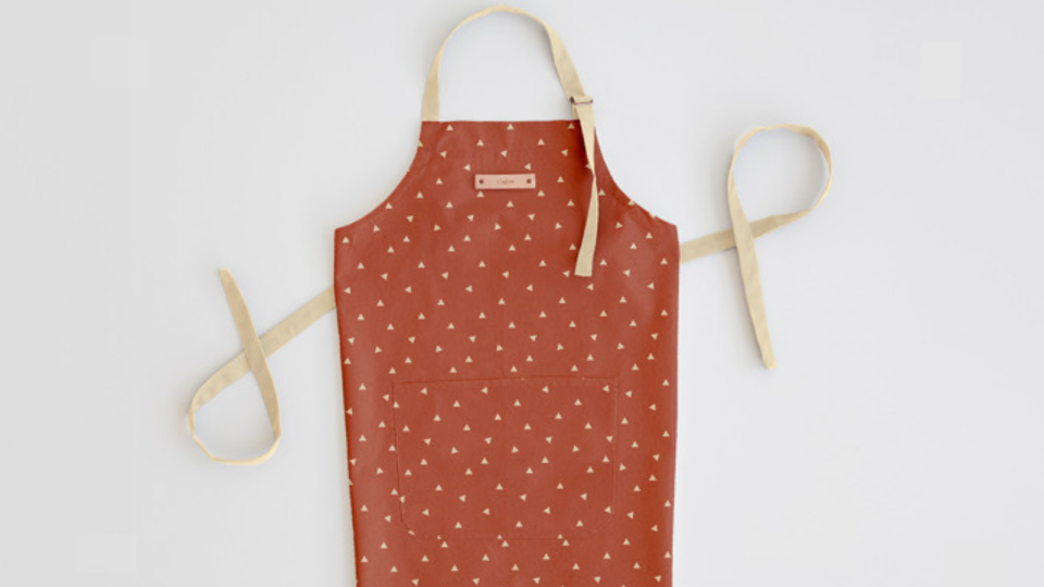 This cute apron has a small leather nametag on the front.