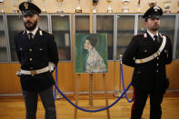 An Italian Policeman, left, and a Carabiniere, paramilitary police officer, stand beside a painting which was found last December near an art gallery and believed to be the missing Gustav Klimt's painting ‘Portrait of a Lady’ during a press conference in Piacenza, Italy, Friday, Jan. 17, 2020. Art experts have confirmed that a stolen painting discovered hidden inside an Italian art gallery's walls is Gustav Klimt's "Portrait of a Lady," Italian prosecutors said Friday. A gardener reported finding an art work inside a bag last month while clearing ivy at the Ricci Oddi Modern Art Gallery in the northern city of Piacenza. “Portrait of a Lady” disappeared from the gallery during renovation work in February 1997. (AP Photo/Antonio Calanni)