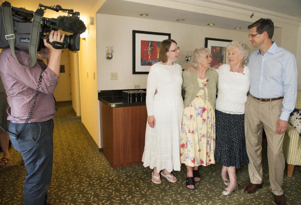 A television crew from the BBC, left, records the May 1, 2014 reunion at the Fullerton Marriott of twin sisters Ann Hunt and Liz Hamel, both 78, in Fullerton, Calif. Pictured, from left, are Samantha Stacey, her mother Ann Hunt, Liz Hamel, and her son, Quinton Hamel. Hunt and Hamel are considered the world's longest-separated twins. (AP Photo/Orange County Register, Leonard Ortiz) MANDATORY CREDIT, LEONARD ORTIZ, ORANGE COUNTY REGISTER