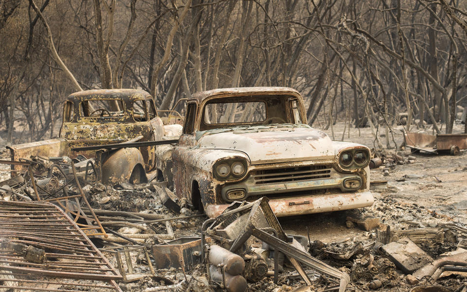 <p>Trucks burned by a wildfire rest in a grove near Oroville, Calif., on Saturday, July 8, 2017. The fast-moving wildfire in the Sierra Nevada foothills destroyed structures, including homes, and led to several minor injuries, fire officials said Saturday as blazes threatened homes around California during a heat wave. (AP Photo/Noah Berger) </p>