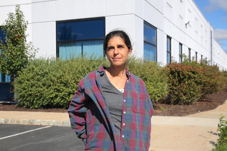 woman in front of a warehouse