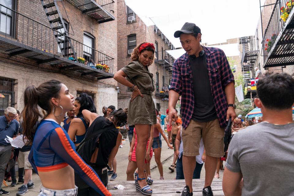 This image released by Warner Bros. Entertainment shows Melissa Barrera, from left, Daphne Rubin-Vega and director Jon M. Chu on the set of "In the Heights," in theaters an HBO Max on June 11.