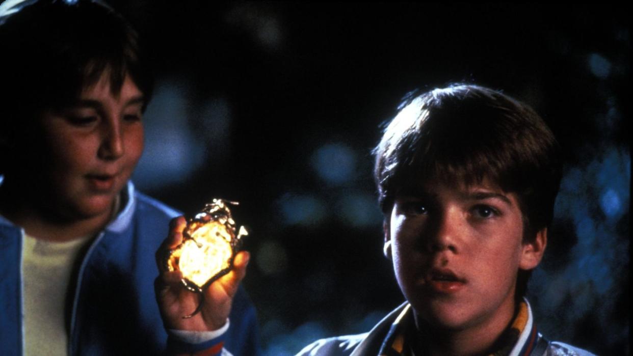 a kid holds dracula's amulet in a scene from the monster squad, a good housekeeping pick for best halloween movies