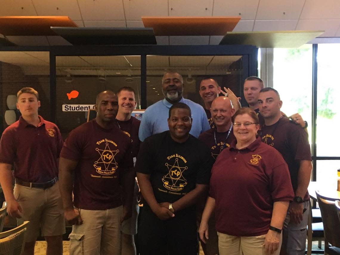 Former NFL Pro Bowler and Super Bowl champion Bryan Cox takes a photo with officers after speaking to the kids and answering questions at the Team Illinois Youth Police Camp. This year’s camp will take place Sunday, July 16, through Saturday, July 22, at Principia College in Elsah, Illinois. Cox is an East St. Louis High School graduate.