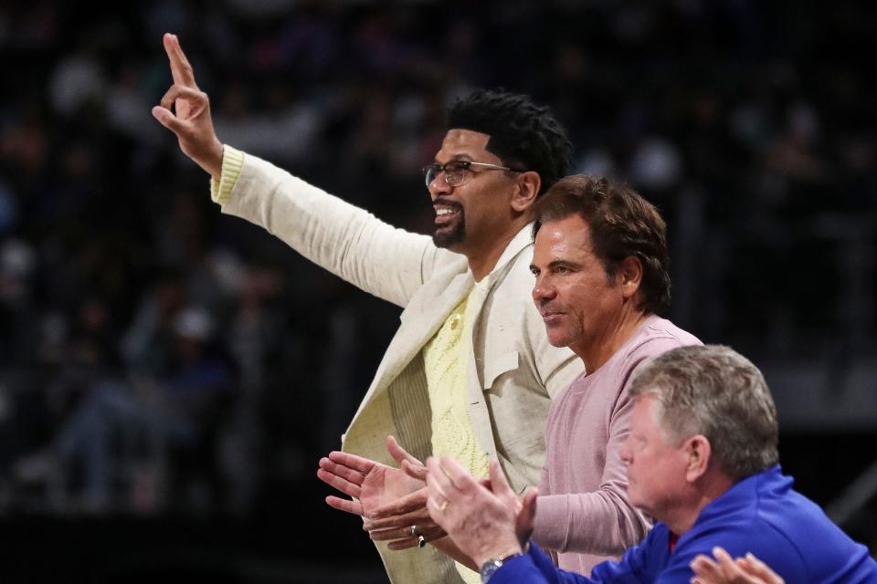 Jalen Rose and Pistons owner Tom Gores celebrate a play against the Nets during the first half on Wednesday, April 5, 2023, at Little Caesars Arena.