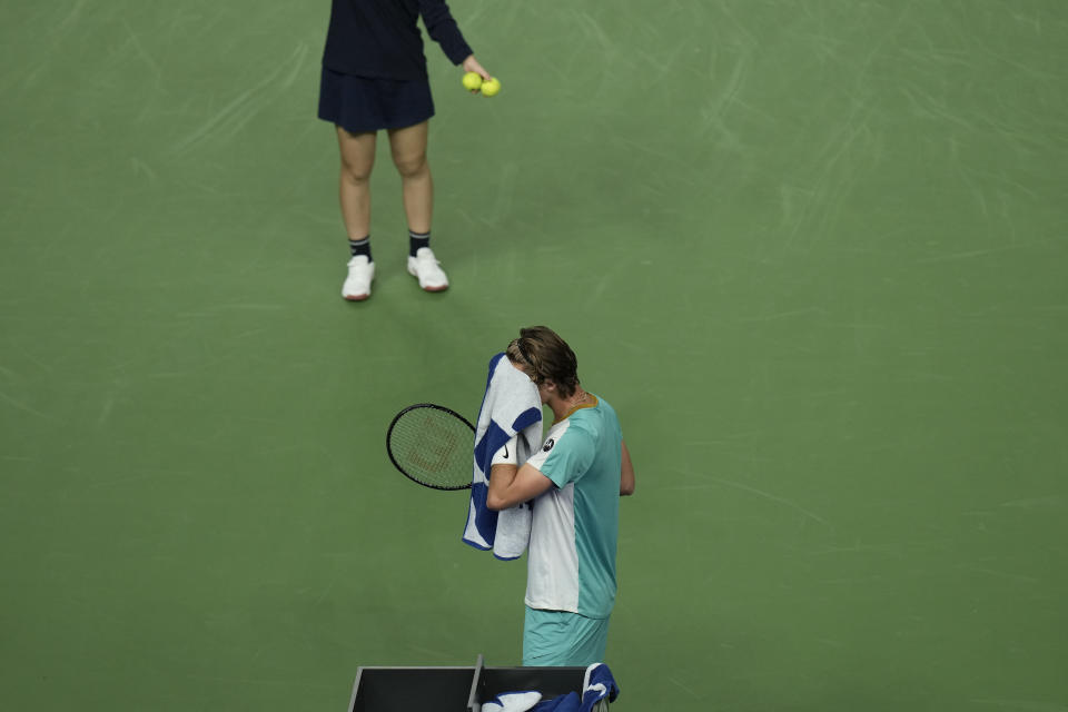 Sebastian Korda of the United States wipes his sweat as he preparing to serve against his compatriot Ben Shelton during the men's singles quarterfinal match in the Shanghai Masters tennis tournament at Qizhong Forest Sports City Tennis Center in Shanghai, China, Thursday, Oct. 12, 2023. (AP Photo/Andy Wong)