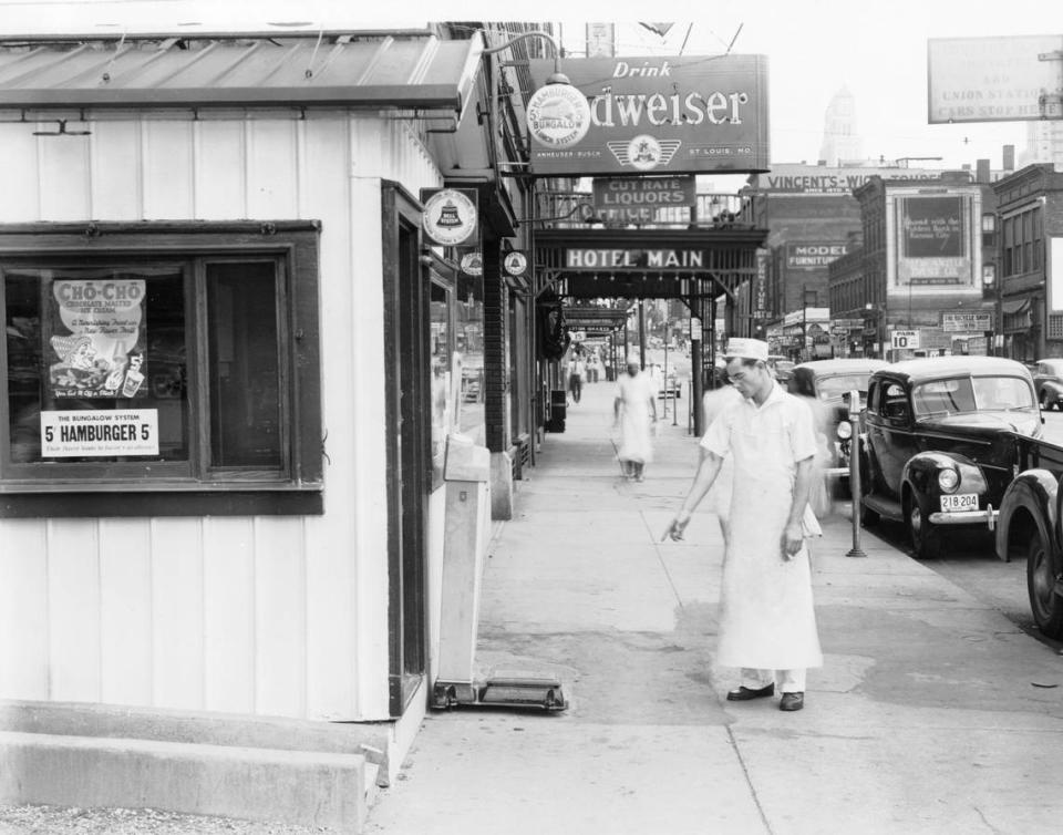 Employee outside a Bungalow location at 1432 Main, 1940