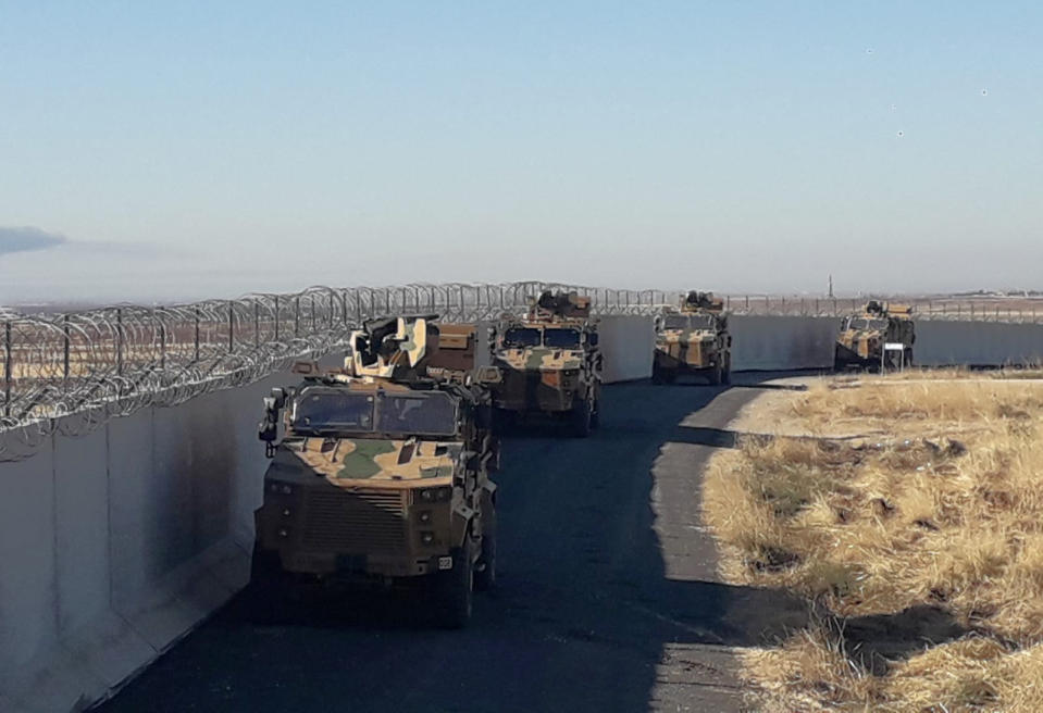 Turkish army armoured vehicles arrive near the Turkish town of Idil at the Turkey-Syria border before Turkish and Russian troops conduct their third joint patrols in northeast Syria, Friday, Nov. 8, 2019. Turkish and Russian troops are conducting joint patrols under a deal between the two countries that forced Syrian Kurdish fighters to withdraw from areas bordering Turkey. (Turkish Defence Ministry via AP, Pool)