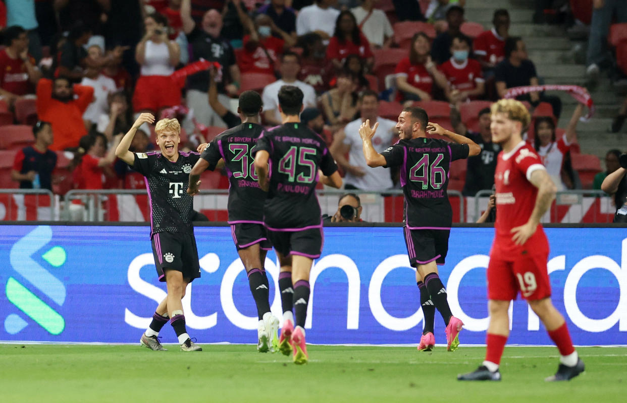 Bayern Munich's Frans Kratzig (left) celebrates scoring their winner against Liverpool in their Festival of Football friendly at the National Stadium in Singapore.