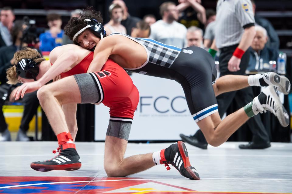 Chambersburg's Karl Shindledecker, right, jumps on top of Easton's Oliver Fairchild  during a 126-pound round of 16 bout at the PIAA Class 3A Wrestling Championships at the Giant Center on Thursday, March 10, 2022, in Derry Township. Shindledecker won by major decision, 10-0, and wrestled to a seventh-place finish.