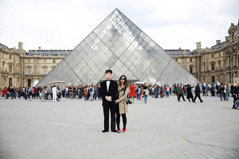 Jinna Yang and a cutout of her father in front of the Louvre in Paris.