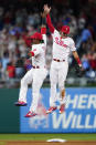 Philadelphia Phillies' Jean Segura, left, and Bryson Stott celebrate after a baseball game against the Pittsburgh Pirates, Friday, Aug. 26, 2022, in Philadelphia. (AP Photo/Matt Slocum)