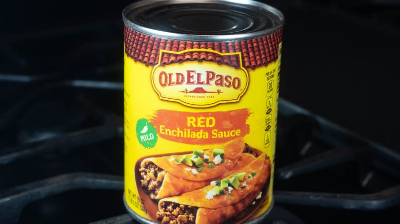 Canned enchilada sauce on black background