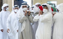 This photo made available by the Ministry of Presidential Affairs, shows Sheikh Mohamed bin Zayed Al Nahyan, ruler of Abu Dhabi, front left, and Sheikh Mansour bin Zayed Al Nahyan, UAE Deputy Prime Minister and Minister of Presidential Affairs, front right, carry the body of Sheikh Khalifa bin Zayed Al Nahyan, president of the United Arab Emirates, with other members of royal family at Sheikh Sultan bin Zayed The First mosque, in Abu Dhabi, Friday, May 13, 2022. (Hamad Al Kaabi/Ministry of Presidential Affairs via AP)