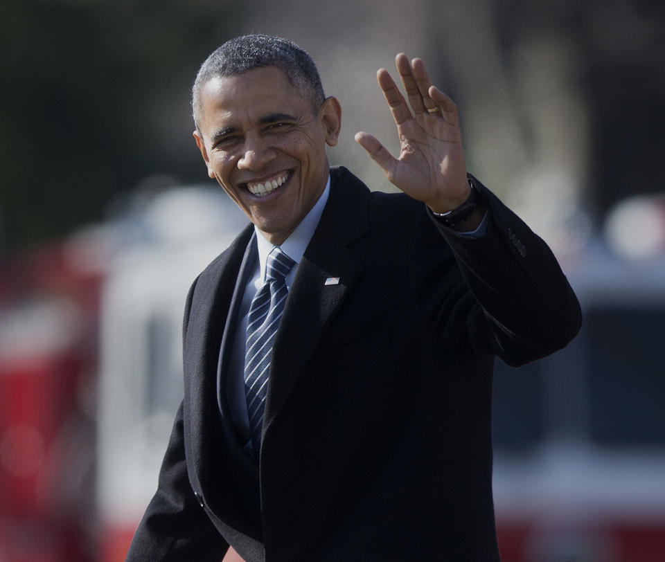 President Barack Obama waves as he walks across the South Lawn of the White House in Washington, Friday, Feb. 7, 2014, before boarding Marine One helicopter. The president is traveling to East Lansing, Mich. to sign the farm bill at Michigan State University. The bill expands federal crop insurance and ends direct government payments to farmers, but the bulk of its cost is for the food stamp program that aids 1 in 7 Americans. (AP Photo/Pablo Martinez Monsivais)