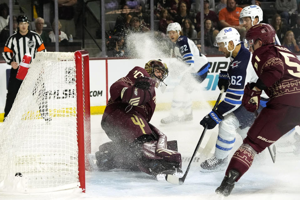 Winnipeg Jets right wing Nino Niederreiter (62) scores a goal against Arizona Coyotes goaltender Karel Vejmelka, left, as Coyotes defenseman Troy Stecher, right, Jets defenseman Ville Heinola, back right, and Jets center Mason Appleton (22) all look on during the second period of an NHL hockey game Saturday, Nov. 4, 2023, in Tempe, Ariz. (AP Photo/Ross D. Franklin)