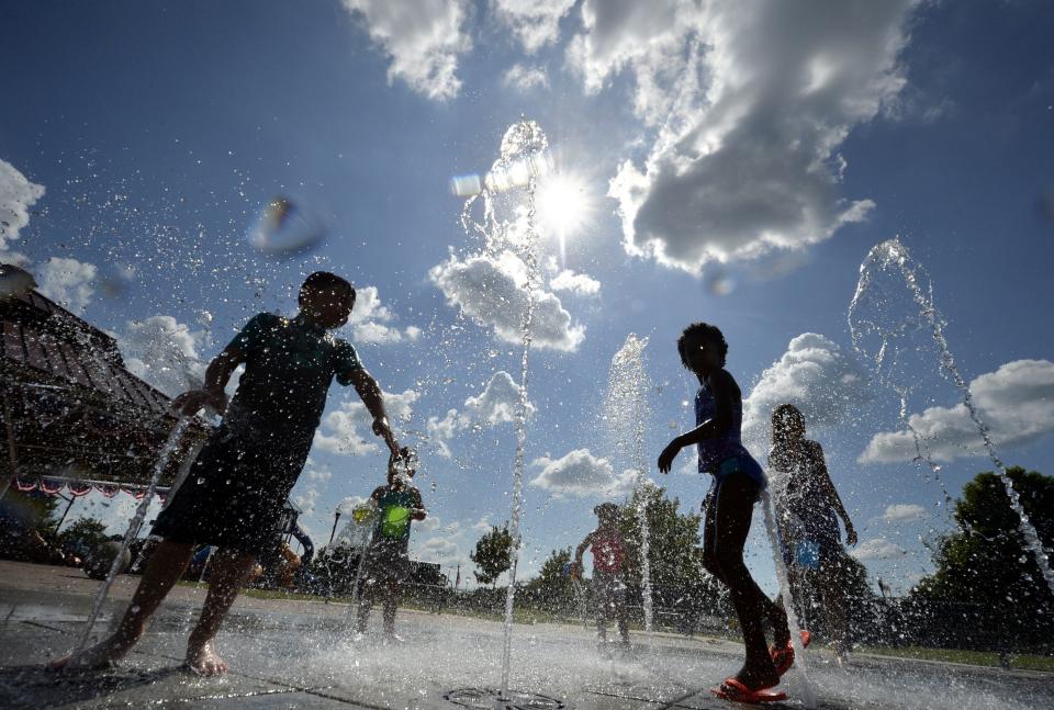 Children frolic in the cool spray of the splash pad at Evans Towne Center Park in Evans, Ga., in this photo from June 2018.