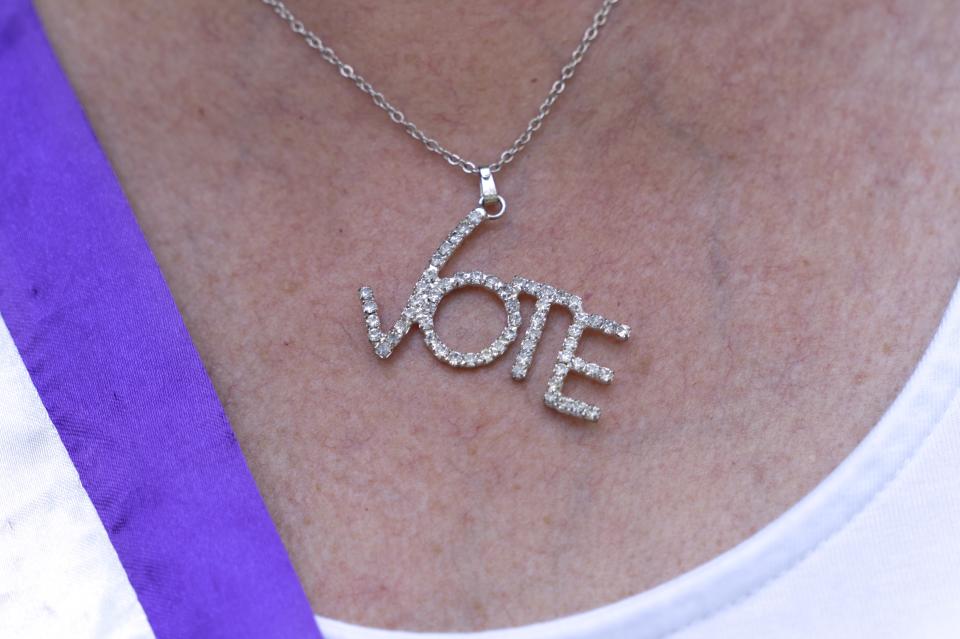 Kathy Chiron, President of the DC Chapter of the League of Women Voters, wears a necklace saying "vote" while attending a rally for voting rights, Tuesday, Aug. 24, 2021, near the White House in Washington. (AP Photo/Jacquelyn Martin)