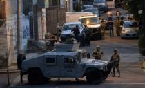 Navy members stand guard following a shoot-out in which eight alleged drug traffickers were shot dead in Mexico City