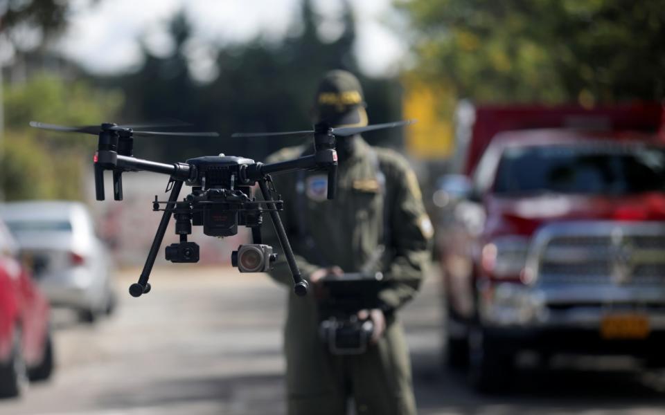 A police officer operates a drone that measures body temperature in Bogota, Colombia  - LUISA GONZALEZ /REUTERS