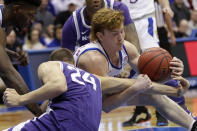 Kansas guard Chris Teahan, right, tangles with Kansas State forward Pierson McAtee (24) during the second half of an NCAA college basketball game in Lawrence, Kan., Tuesday, Jan. 21, 2020. Kansas defeated Kansas State 81-59. (AP Photo/Orlin Wagner)