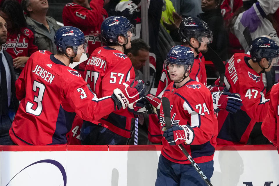 Washington Capitals center Connor McMichael (24) celebrates his goal with his teammates in the second period of an NHL hockey game against the Calgary Flames, Monday, Oct. 16, 2023, in Washington. (AP Photo/Alex Brandon)