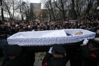 Pallbearers carry the coffin with the body of Russian leading opposition figure Boris Nemtsov, as people throw flowers in the background, during a memorial service before the funeral in Moscow, March 3, 2015. Thousands of Russians, many carrying red carnations, queued on Tuesday to pay their respects to Boris Nemtsov, the Kremlin critic whose murder last week showed the hazards of speaking out against Russian President Vladimir Putin. (REUTERS/Maxim Zmeyev)