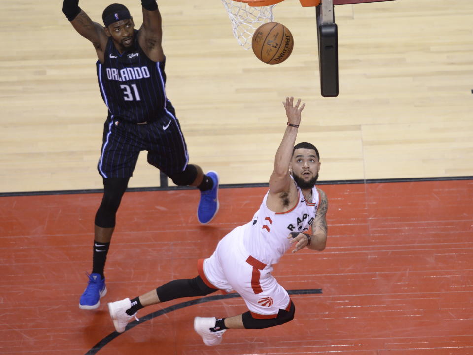 Toronto Raptors guard Fred VanVleet (23) makes a basket as Orlando Magic guard Terrence Ross (31) looks on during the second half in Game 1 of a first-round NBA basketball playoff series in Toronto, Saturday, April 13, 2019. (Nathan Denette/The Canadian Press via AP)