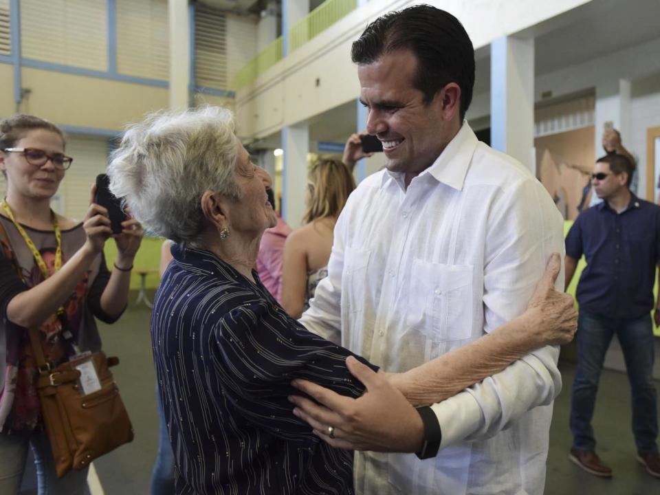 Governor Ricardo Rossello greets people before voting (Associated Press)