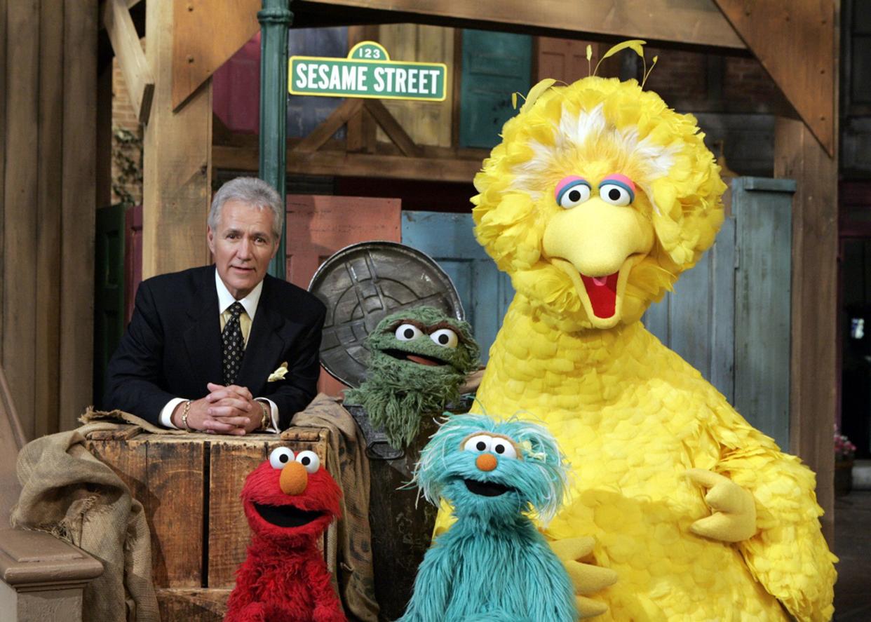 Alex Trebek visits with some of the Muppet cast of "Sesame Street" at Kaufman Astoria Studios in New York on Nov. 17, 2005.