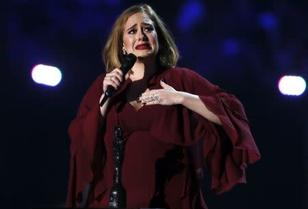 Adele reacts as she accepts the global success award at the BRIT Awards at the O2 arena in London, February 24, 2016. REUTERS/Stefan Wermuth