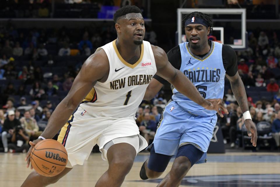 New Orleans Pelicans forward Zion Williamson (1) drives ahead of Memphis Grizzlies guard Vince Williams Jr., right, in the first half of an NBA basketball game Monday, Feb. 12, 2024, in Memphis, Tenn. (AP Photo/Brandon Dill)