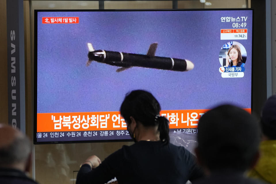 People watch a TV showing a file image of North Korea's missile launch during a news program at the Seoul Railway Station in Seoul, South Korea, Tuesday, Sept. 28, 2021. North Korea on Tuesday fired a suspected ballistic missile into the sea, Seoul and Tokyo officials said, the latest in a series of weapons tests by Pyongyang that raised questions about the sincerity of its recent offer for talks with South Korea. The Korean letters read: "After the announcement of the inter-Korean talks." (AP Photo/Ahn Young-joon)