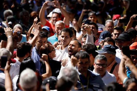 FILE PHOTO: Juan Guaido, President of the Venezuelan National Assembly and lawmaker of the opposition party Popular Will (Voluntad Popular), greets supporters during a gathering in La Guaira, Venezuela January 13, 2019. REUTERS/Carlos Garcia Rawlins/File Photo