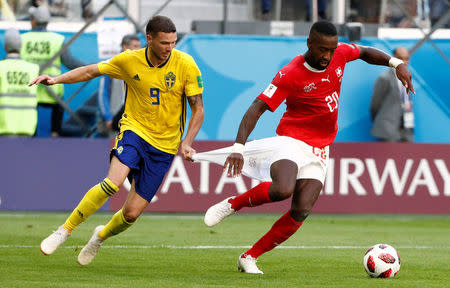 Soccer Football - World Cup - Round of 16 - Sweden vs Switzerland - Saint Petersburg Stadium, Saint Petersburg, Russia - July 3, 2018 Switzerland's Johan Djourou in action with Sweden's Marcus Berg REUTERS/Max Rossi