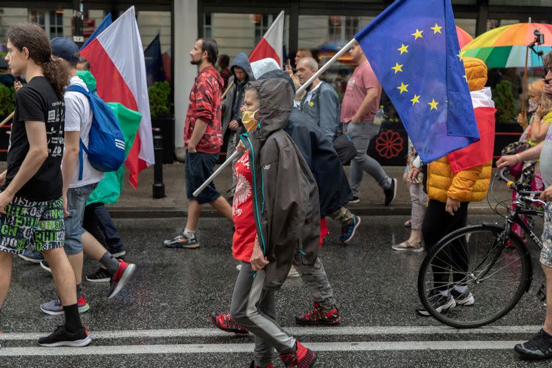 People participate in an anti-government demonstration in Warsaw